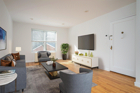 a living room with a couch and a table and a tv